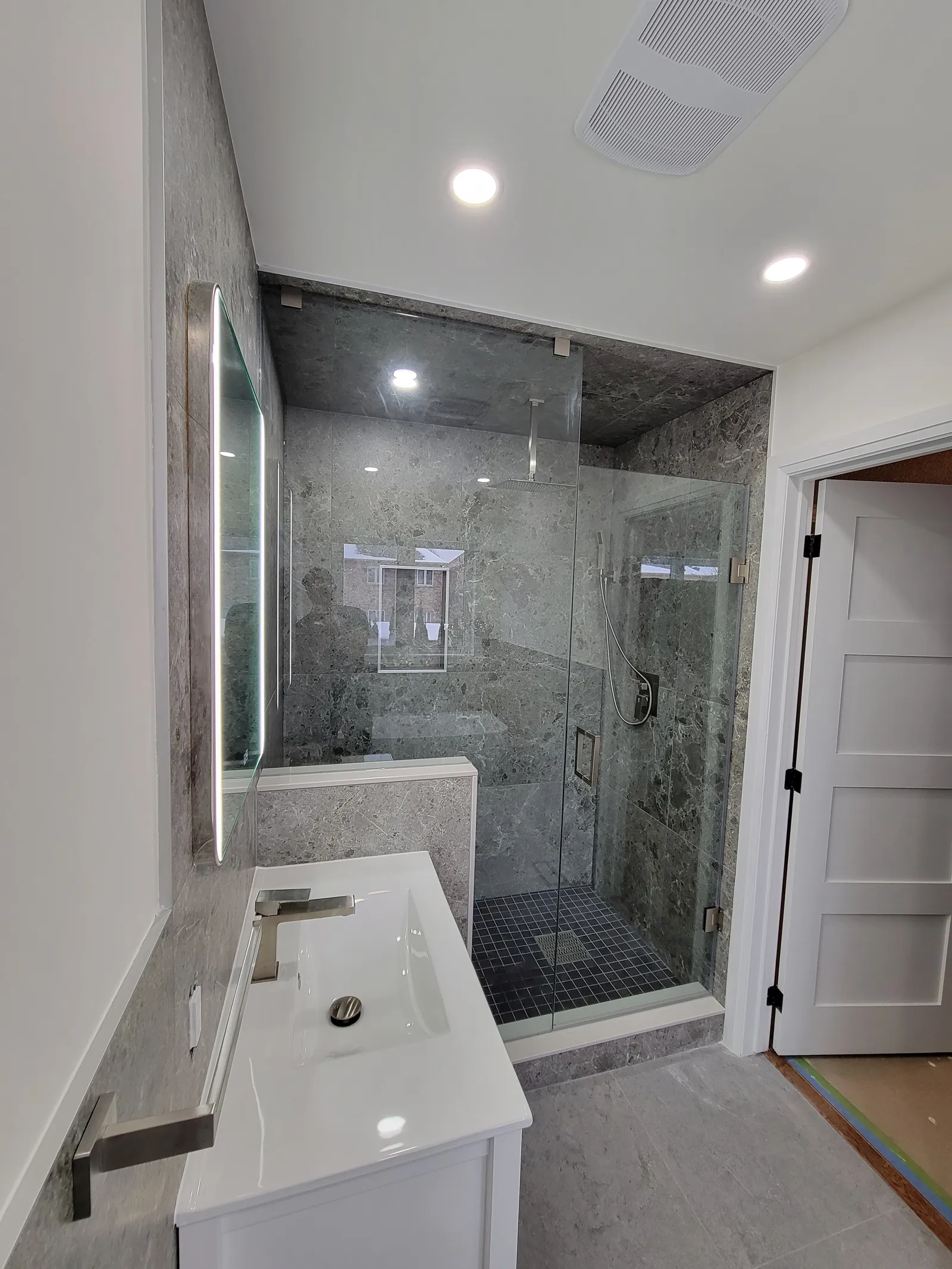 Renovated master bathroom with a frameless glass walk-in shower in Aurora