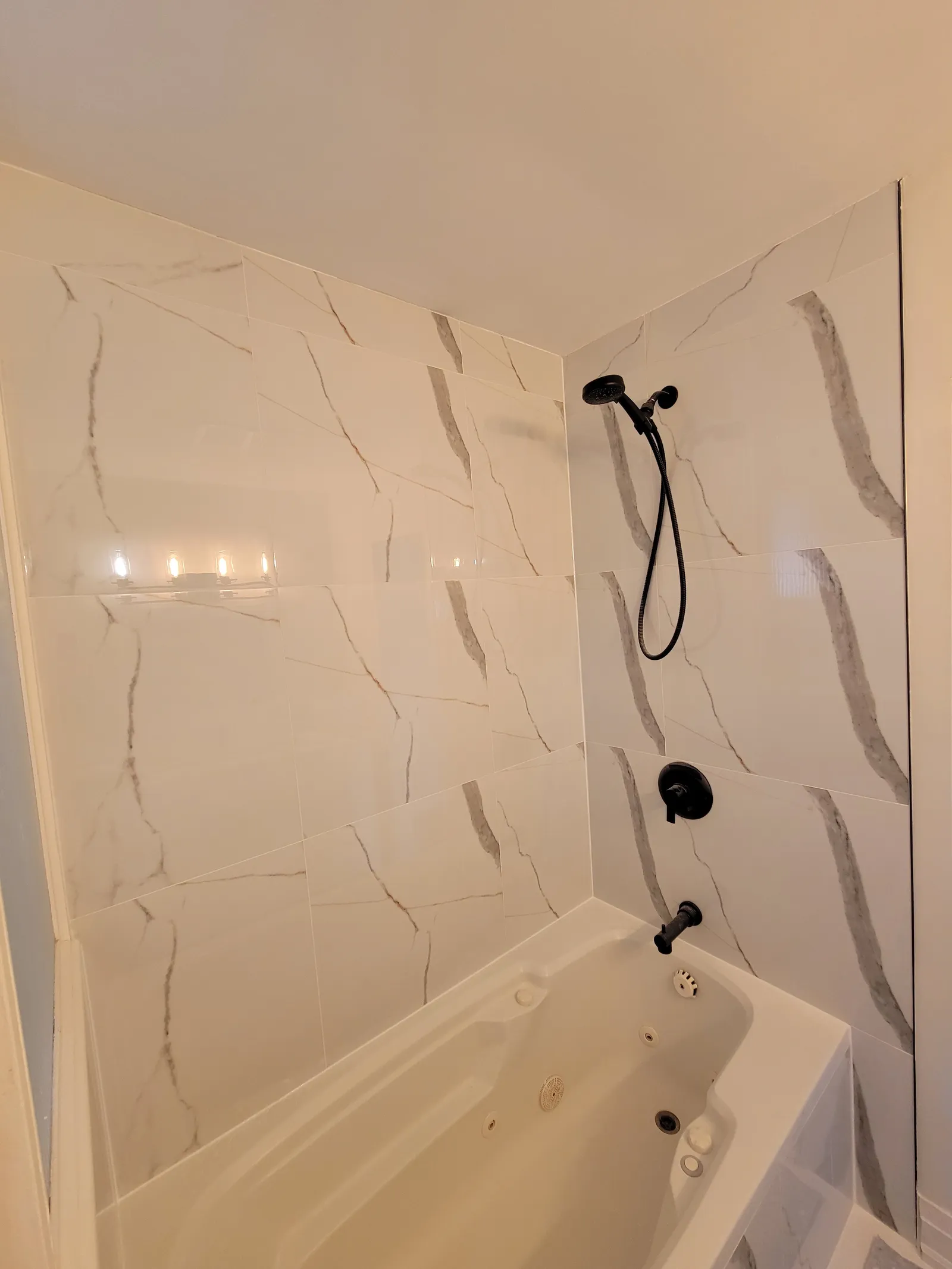 Completed project: a bathtub surround re-tiled in Aurora